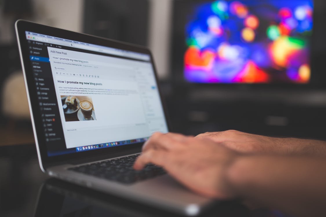 man typing on laptop